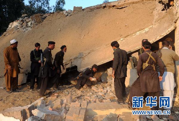 People clear the rubble at the site of a suicide bombing in northwest Pakistan&apos;s Mohmand region on December 6, 2010. Two suicide bombers Monday targeted a meeting of pro-government tribal elders in a Pakistani tribal region, killing at least 50 people with 120 others injured.