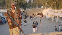 A security member guards at the site of a suicide bombing in northwest Pakistan's Mohmand region on December 6, 2010.