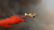 A fire-fighting aircraft drops water over a forest fire near Isfiya, on Mount Carmel, near Haifa, north Israel, Dec. 5, 2010.