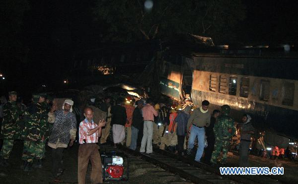Rescuers work on the scene after a collision of two passenger trains in Narsingdi, 51 km northeast of Bangladesh's capital Dhaka on Dec. 8, 2010. 