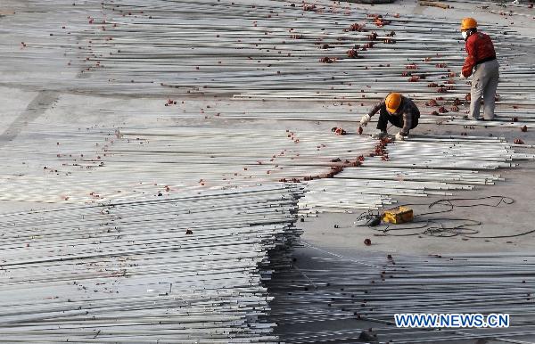 Workers take off the acrylic rods of the UK Pavilion in the World Expo Park in Shanghai, east China, Dec. 8, 2010. The 