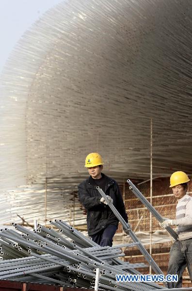 Workers take off the acrylic rods of the UK Pavilion in the World Expo Park in Shanghai, east China, Dec. 8, 2010. The 