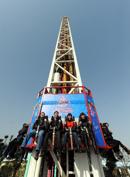 Visitors ride at an attraction at Fantawild Dreamland in Wuhu, east China's Anhui Province, Dec. 8, 2010. 