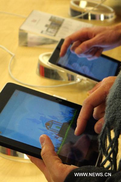 Customers play the 'Angry Birds' on iPads at the flagship store of Apple Inc. in New York, the United States, Dec. 12, 2010. 