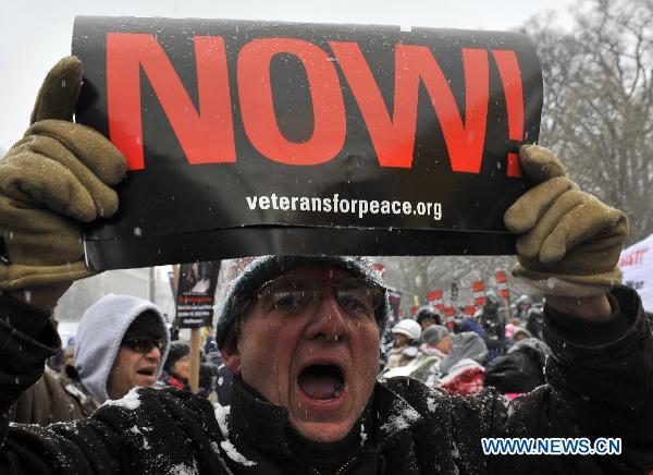 An anti-war protestor attends a demonstration outside the White House in Washington D.C., the United States, Dec. 16, 2010. 