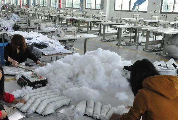Photo taken on Dec. 16, 2010 shows idle equipments at a plant of a clothes and shoes factory in Putian, southeast China's Fujian Province. 