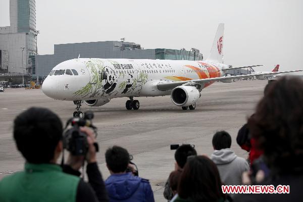 The chartered plane carrying pandas 'Kai Kai' and 'Xin Xin' arrives at the airport in Macao, south China, Dec. 18, 2010.