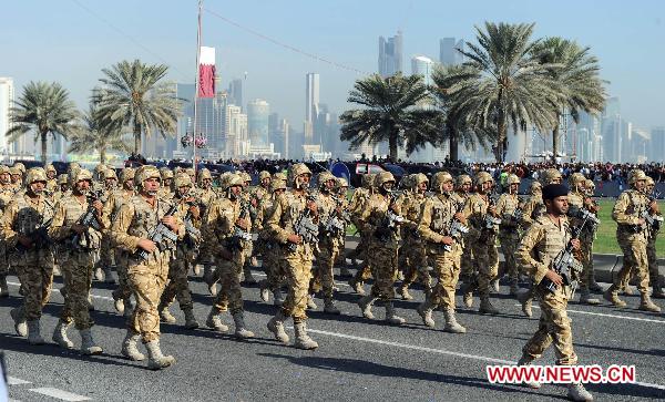 Soldiers take part in a military parade during Qatar&apos;s National Day in Doha, Qatar, on Dec. 18, 2010.