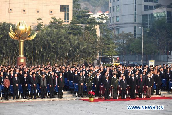 China's mainland and Macao officials, as well as invited guests, attend the flag-raising ceremony marking the 11th anniversary of Macao's handover at the Golden Lotus Square in Macao Special Administrative Region, south China, Dec. 20, 2010.