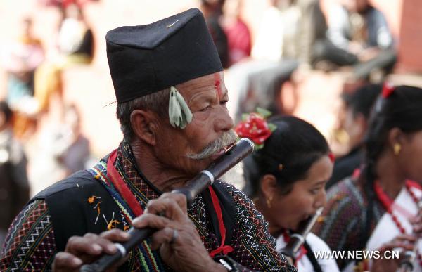 A Nepalese ethnic Newar musician plays traditional flute during the celebrations of Yomari Punhi festival in Kathmandu, capital of Nepal, Dec. 21, 2010.