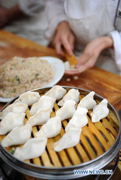 A staff member of a restaurant makes dumplings in Yinchuan, capital of northwest China&apos;s Ningxia Hui Autonomous Region, Dec. 21, 2010. 