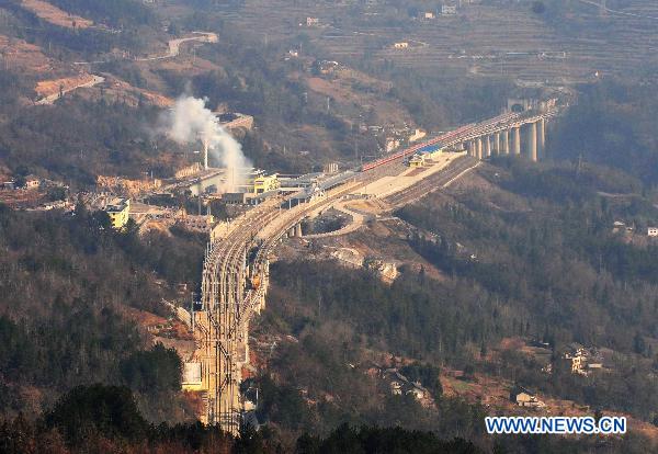 A train runs past the Badong station along the Yichang-Wanzhou railway in central China's Hubei Province, Dec. 22, 2010. 