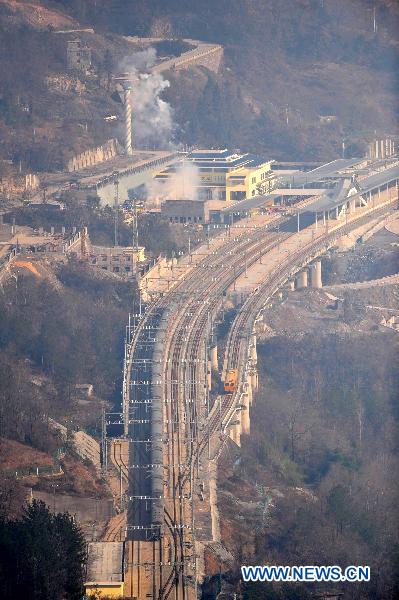 A train runs past the Badong station along the Yichang-Wanzhou railway in central China's Hubei Province, Dec. 22, 2010. 