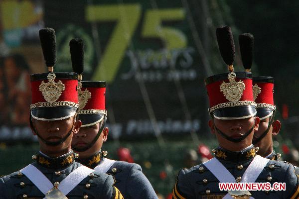 Soldiers stand in attention during the celebration of the 75th founding anniversary of the Armed Forces of the Philippines at Camp Aguinaldo in Quezon City, Dec. 21, 2010.