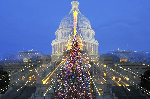 A Christmas tree is seen lighten up in front of the Capitol Hill in Washington D.C., capital of the United States, Dec. 21, 2010.