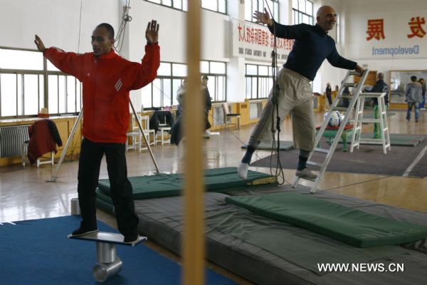 Students from Egypt practise sense of balance of acrobatics at Wuqiao acrobatic art school in Wuqiao County, north China's Hebei Province, Dec. 23, 2010.