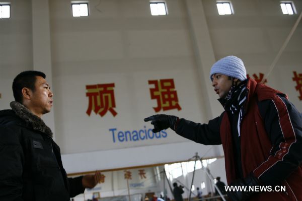 Mohamed (R) from Egypt communicates with his Chinese instructor at Wuqiao acrobatic art school in Wuqiao County, north China's Hebei Province, Dec. 23, 2010. 
