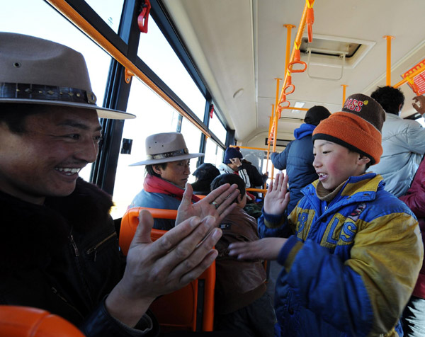 Passengers take one of the 232 new buses in Lhasa, capital of the Tibet Autonomous Region on Dec 26, 2010.