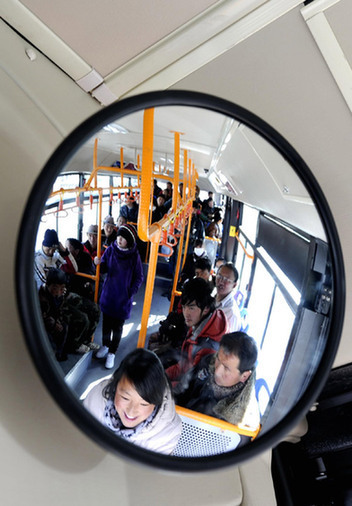 Passengers take one of the 232 new buses in Lhasa, capital of the Tibet Autonomous Region on Dec 26, 2010.
