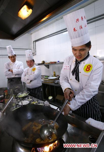 A contestant stir-fries the food during a cooking competition in Changping District in Beijing, capital of China, Dec. 26, 2010.