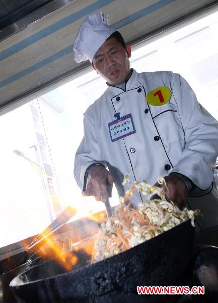 A contestant cooks during a cooking competition in Changping District in Beijing, capital of China, Dec. 26, 2010.