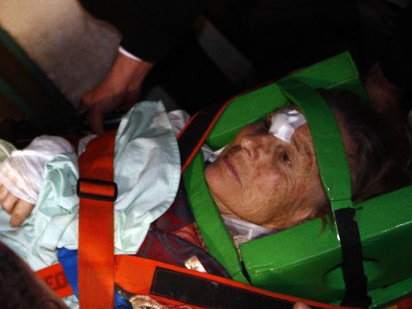 An unidentified injured tour bus passenger is evacuated from an ambulance into Nasser Institute Hospital in Cairo, Egypt, Dec. 26, 2010. 