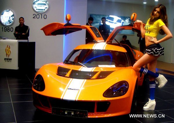 A model promotes a sports car at the 8th China Guangzhou International Automobile Exhibition in Guangzhou, capital of south China's Guangdong Province, Dec. 27, 2010. 