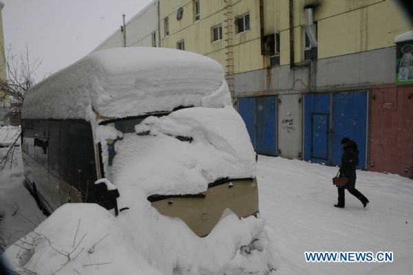 A citizen walks in heavy snow, in Altay City, northwest China's Xinjiang Uygur Autonomous Region, Dec. 27, 2010.