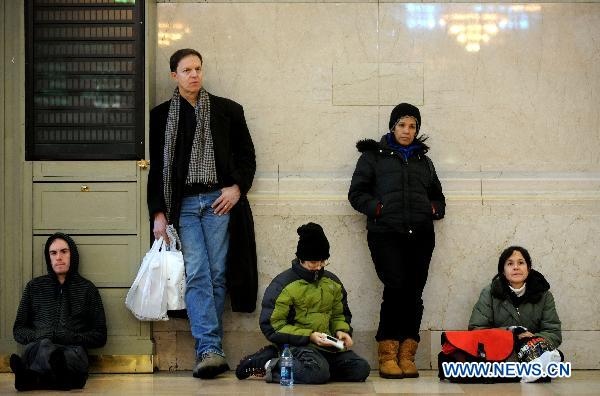 Commuters wait for their delayed train in Grand Central in Manhattan of New York, the United States, Dec. 27, 2010. 