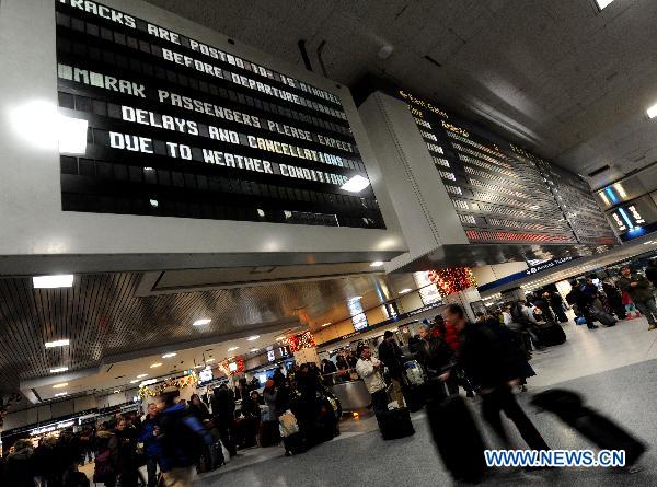 Commuters wait at Pennsylvania Station in Manhattan of New York, the United States, Dec. 27, 2010. 