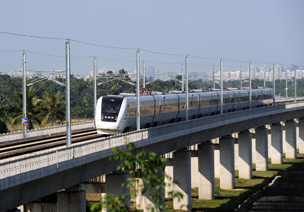 A bullet train runs during a trial operation on the East Ring Railway, or Donghuan Railway linking Haikou, capital of South China&apos;s island province Hainan and Sanya City, Dec 26, 2010.