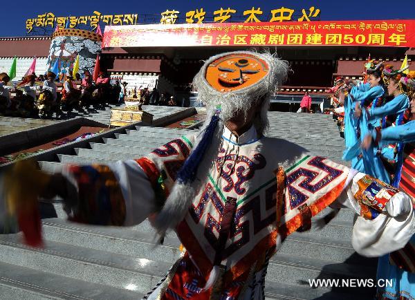 Performers dance during a celebration to mark the 50th anniversary of the founding of Tibetan Opera Troupe in Lhasa, capital of southwest China's Tibet Autonomous Region, Dec. 28, 2010. 