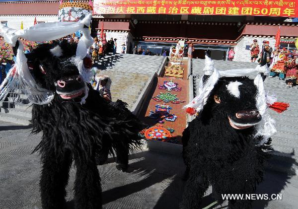Performers stage yak dance during a celebration to mark the 50th anniversary of the founding of Tibetan Opera Troupe in Lhasa, capital of southwest China's Tibet Autonomous Region, Dec. 28, 2010. 