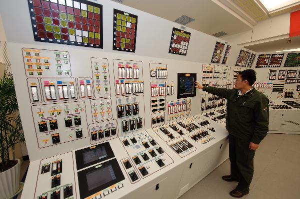 A technician controls the electronic facility of a nuclear power plant simulator at the Ningde nuclear power plant, southeast China's Fujian Province, Dec. 28, 2010. 