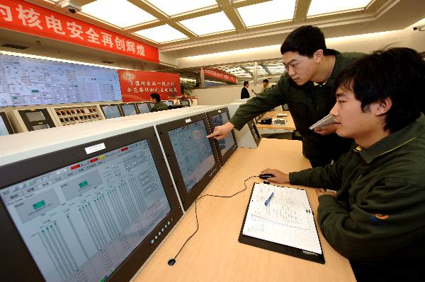 Technicians operate a nuclear power plant simulator during training courses at the Ningde nuclear power plant, southeast China's Fujian Province, Dec. 28, 2010.