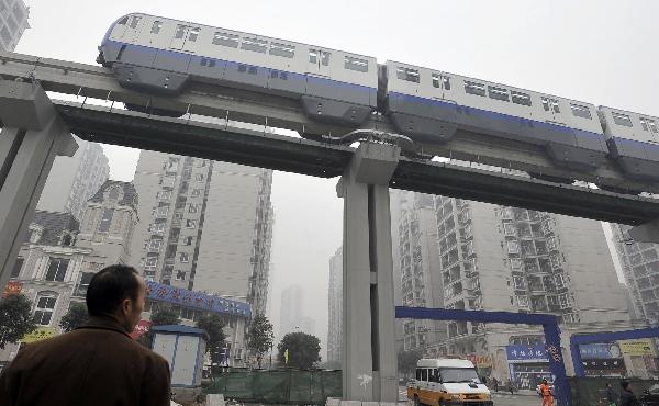 A trial train of Chongqing Subway Line No.3 runs on elevated rail in southwest China&apos;s Chongqing Municipality, Dec. 28, 2010. 