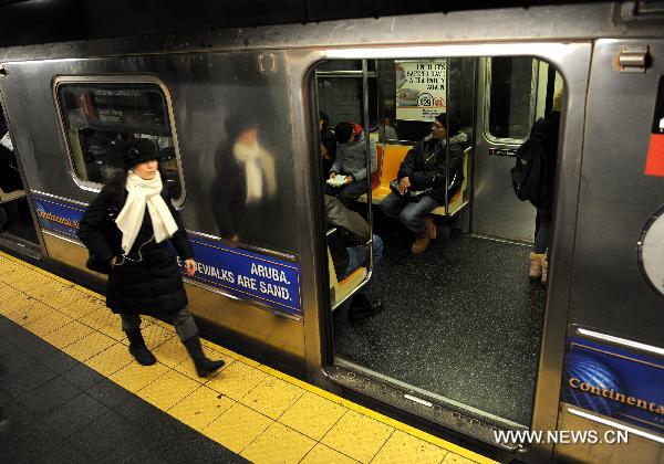 A passenger walks in a subway station in New York, the United States, Dec. 30, 2010. 