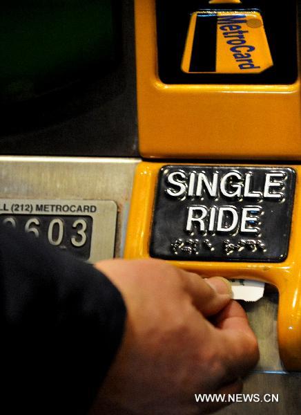 A passenger buys a single ride ticket at a subway station in New York, the United States, Dec. 30, 2010. 