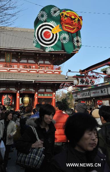 Locals tour Senso-ji during the New Year holiday in Tokyo, capital of Japan, on Dec. 29, 2010.