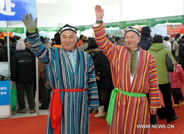 Businessmen dressing in Uygur costume welcome consumers at a bazar in Nanjing, capital of east China's Jiangsu Province, Jan. 2, 2011. 