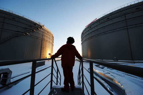A worker inspects the oil tanks at a plant in Mohe County, northeast China's Heilongjiang Province, Jan 1, 2011.