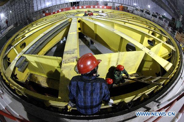 Workers work at the Three Gorges' underground power station in Yichang, central China's Hubei Province, Jan. 2, 2011. The underground turbines were being installed at the underground power station. Two underground turbines of the hydropower project are expected to be put into operation before June 30, 2011. 