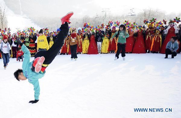 People enjoy themselves at the 16th Jilin international rime and snow festival in Jilin City, of northeast China's Jilin Province, Jan. 4, 2011. 