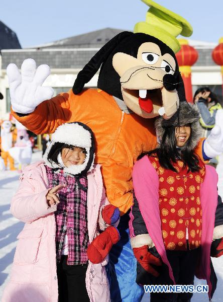 People pose for photos at the 16th Jilin international rime and snow festival in Jilin City, of northeast China's Jilin Province, Jan. 4, 2011.