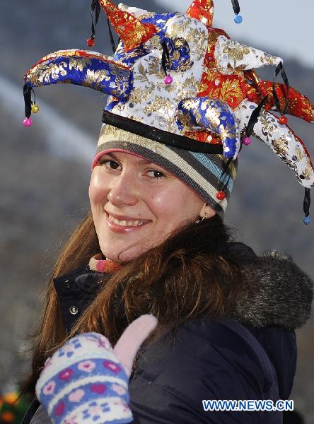 A tourist enjoys herself at the 16th Jilin international rime and snow festival in Jilin City, of northeast China's Jilin Province, Jan. 4, 2011. 