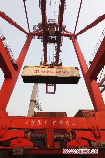 A crane loads a container in the port of Lianyungang, east China's Jiansu Province, Jan. 5, 2011. 