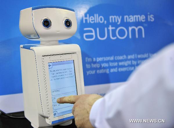 Customers communicate with the health coach Autom during the 2011 International Consumer Electronics Show in Las Vegas, the United States, Jan. 8, 2011. 
