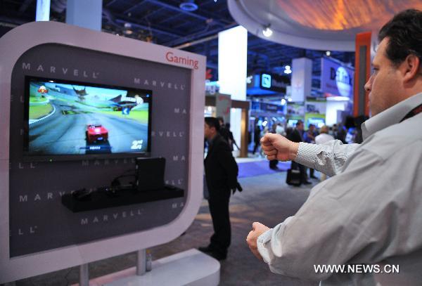 People try out the electric game product during the 2011 International Consumer Electronics Show in Las Vegas, the United States, Jan. 8, 2011.