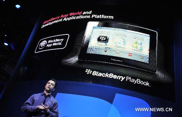 People introduces the BlackBerry Playbook product during the 2011 International Consumer Electronics Show in Las Vegas, the United States, Jan. 8, 2011.