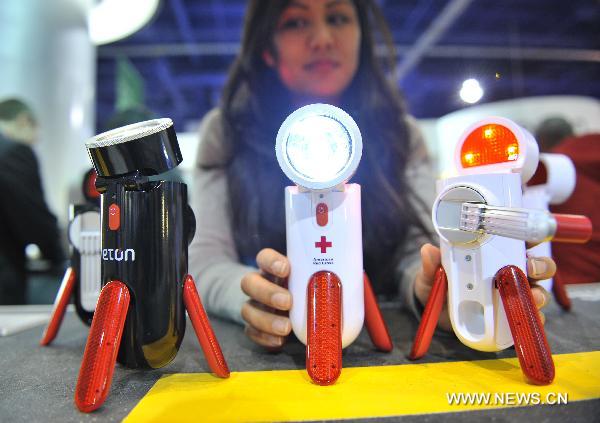 People shows the Road Torq, Self Powered Spotlight and Emergency Beacon during the 2011 International Consumer Electronics Show in Las Vegas, the United States, Jan. 8, 2011. 